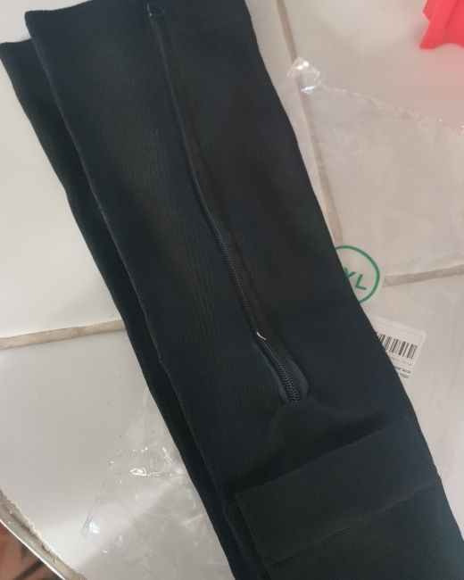 A buyer's black zip sock laid flat with the side zip visible